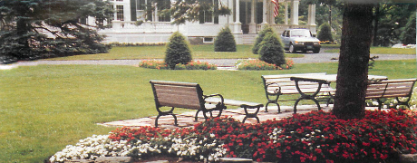 Group 3 Section Image - Picnic table and chairs in front of mansion